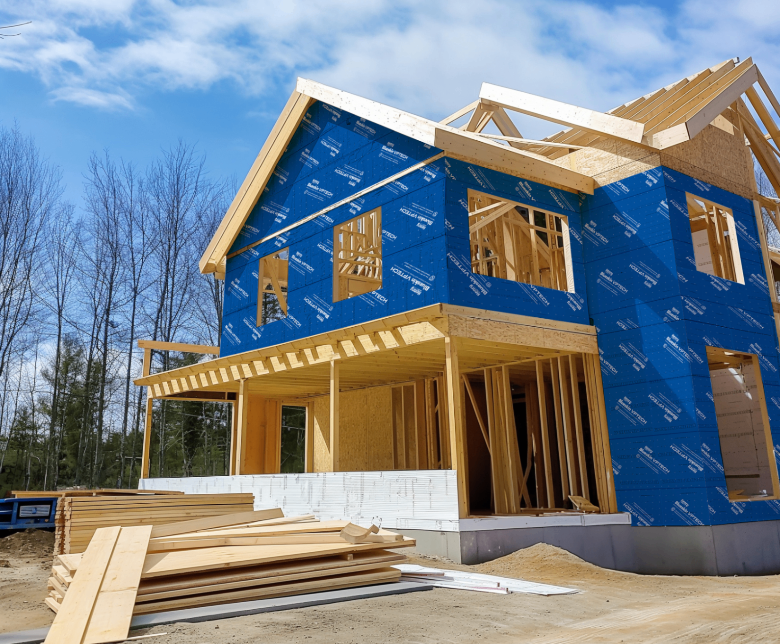 Multi-story AGC new-build residence sheathed in blue weather-resistive wrap during envelope construction