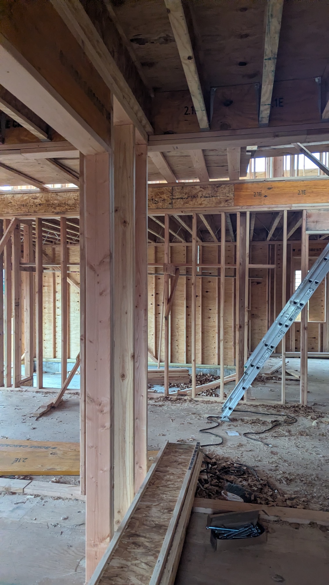 Interior of an AGC new build showing wood stud framing, engineered beams, and floor joists